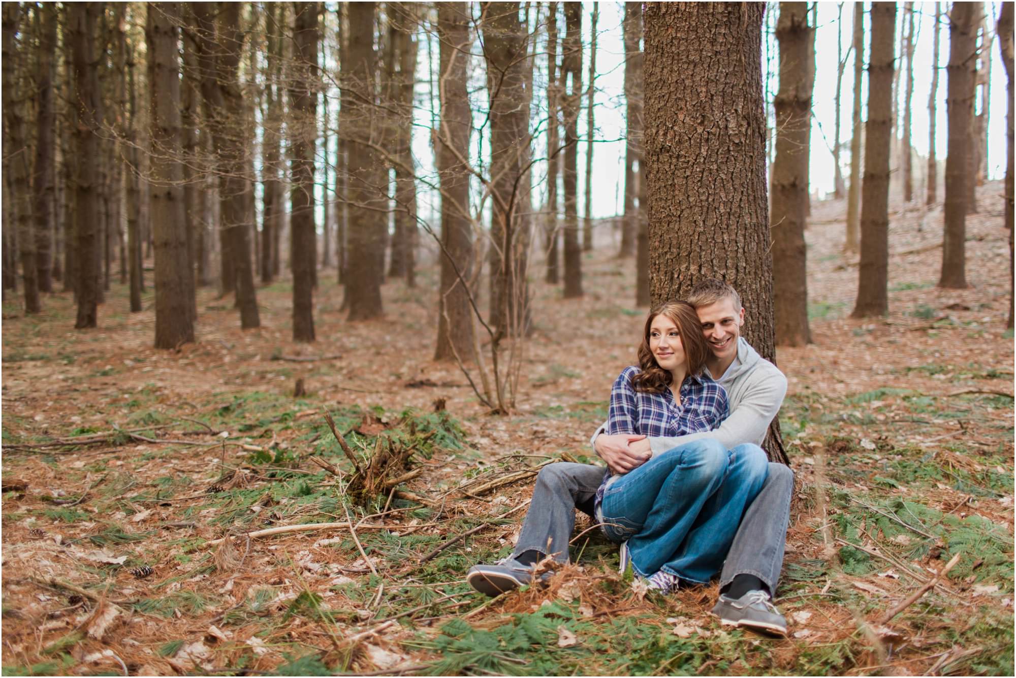 couple cuddling in woods