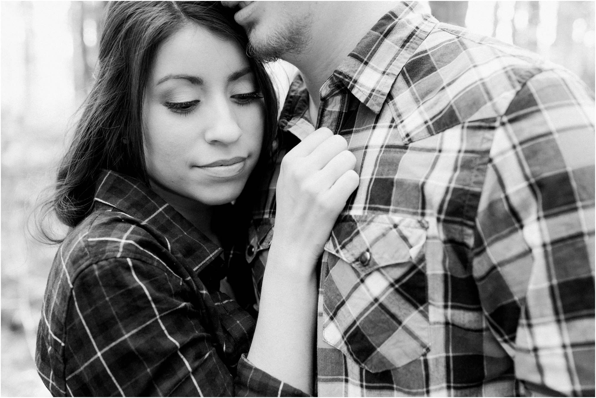 Couple in plaid for pillow fight engagement session