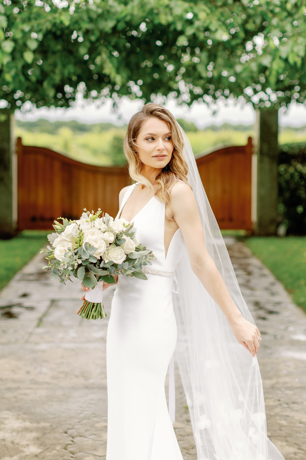 Bride in wedding gown holding her bouquet at Saltwater Farm Vineyard