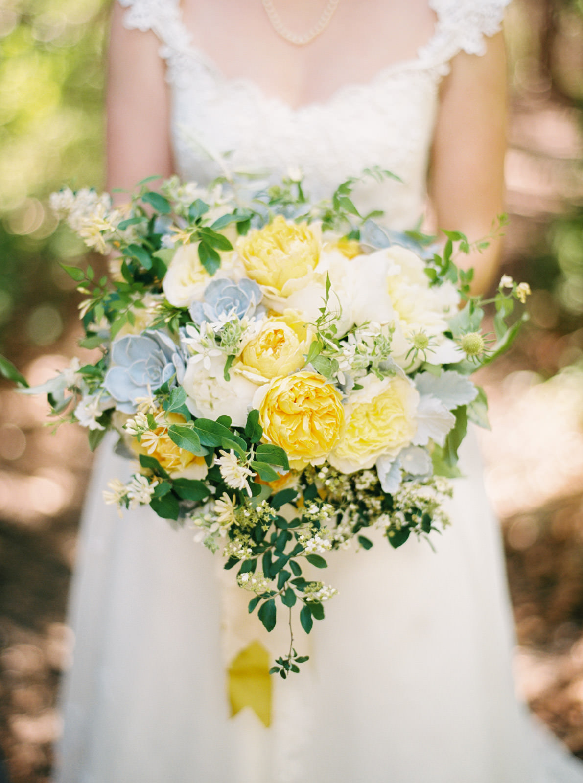 Yellow wedding bouquet being held by bride in Eastham Massachusetts