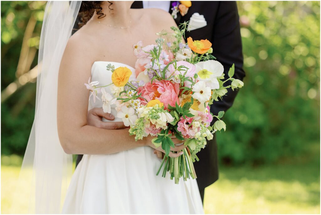 bride holding colorful wedding bouquet