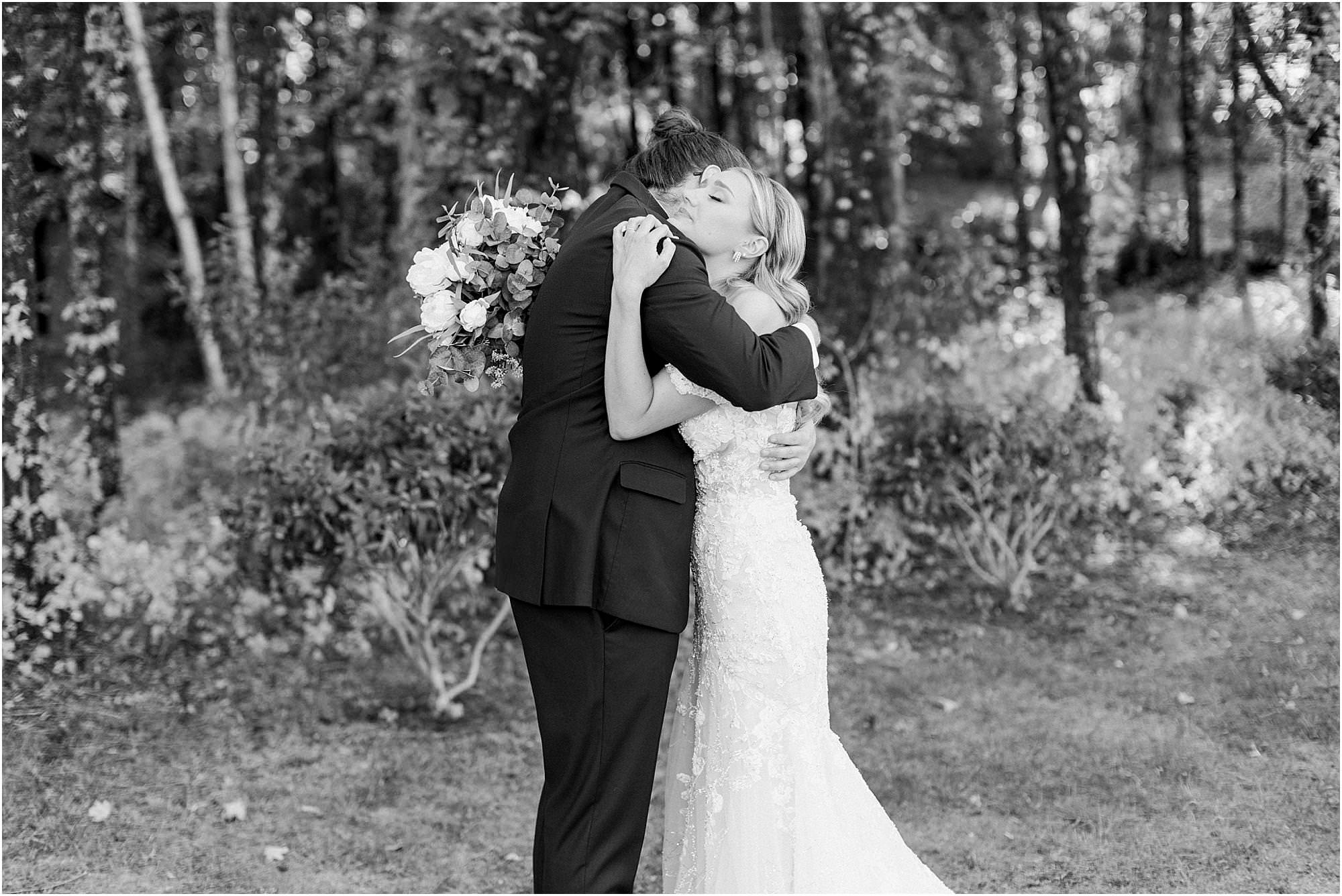 Black and white photo of couple hugging during their first look before their ceremony