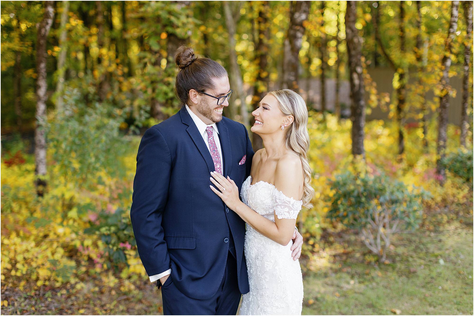 Bride and groom looking at each other during their first look portraits at Stonehurst at Hampton Valley