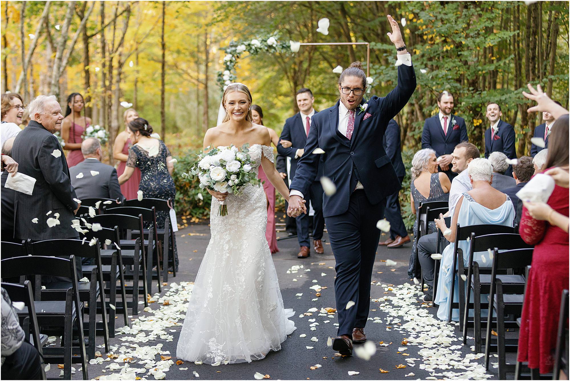 Bride and groom during petal toss at recessional